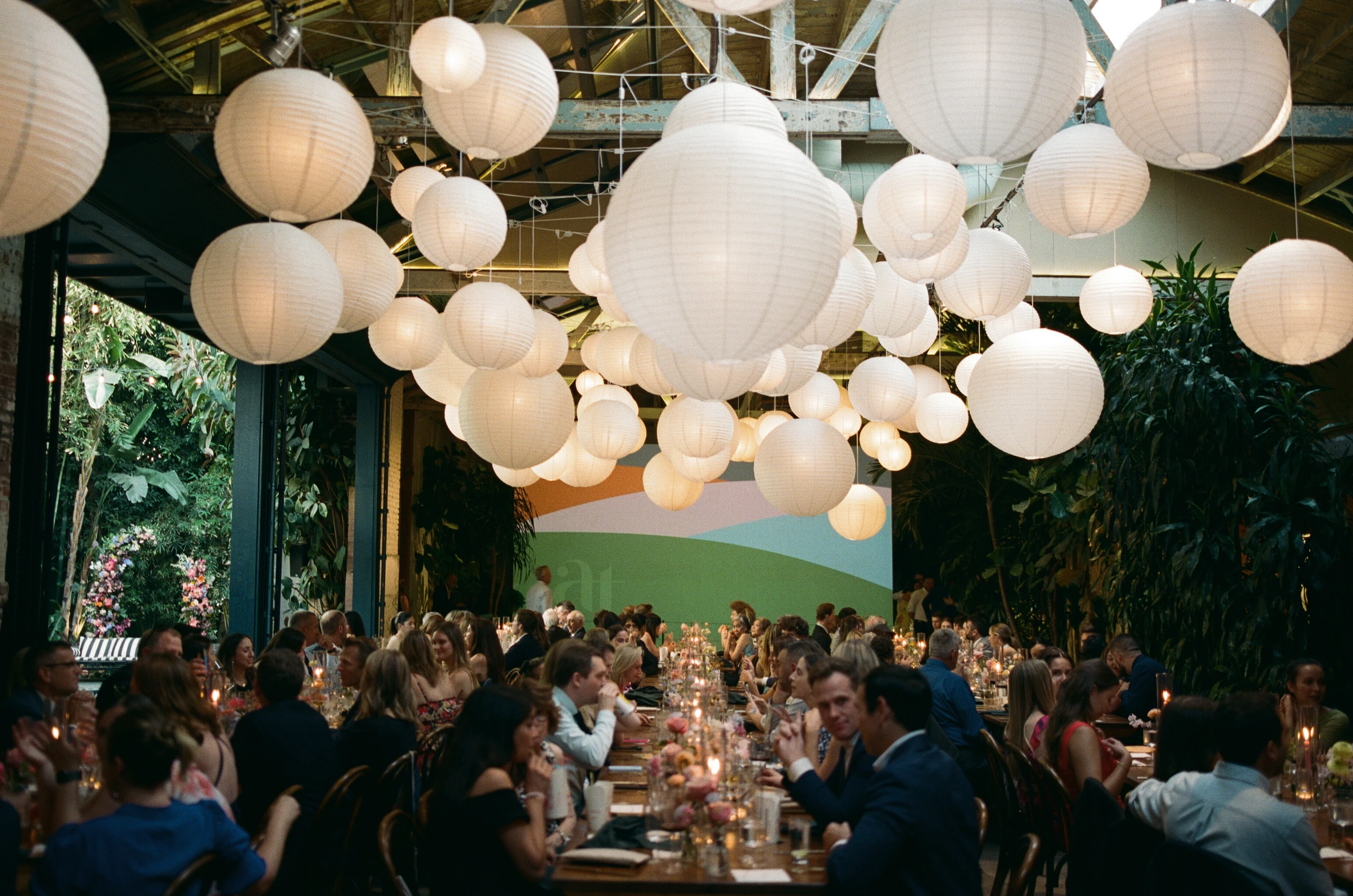 Guests beneath paper lanterns at a Millwick wedding reception