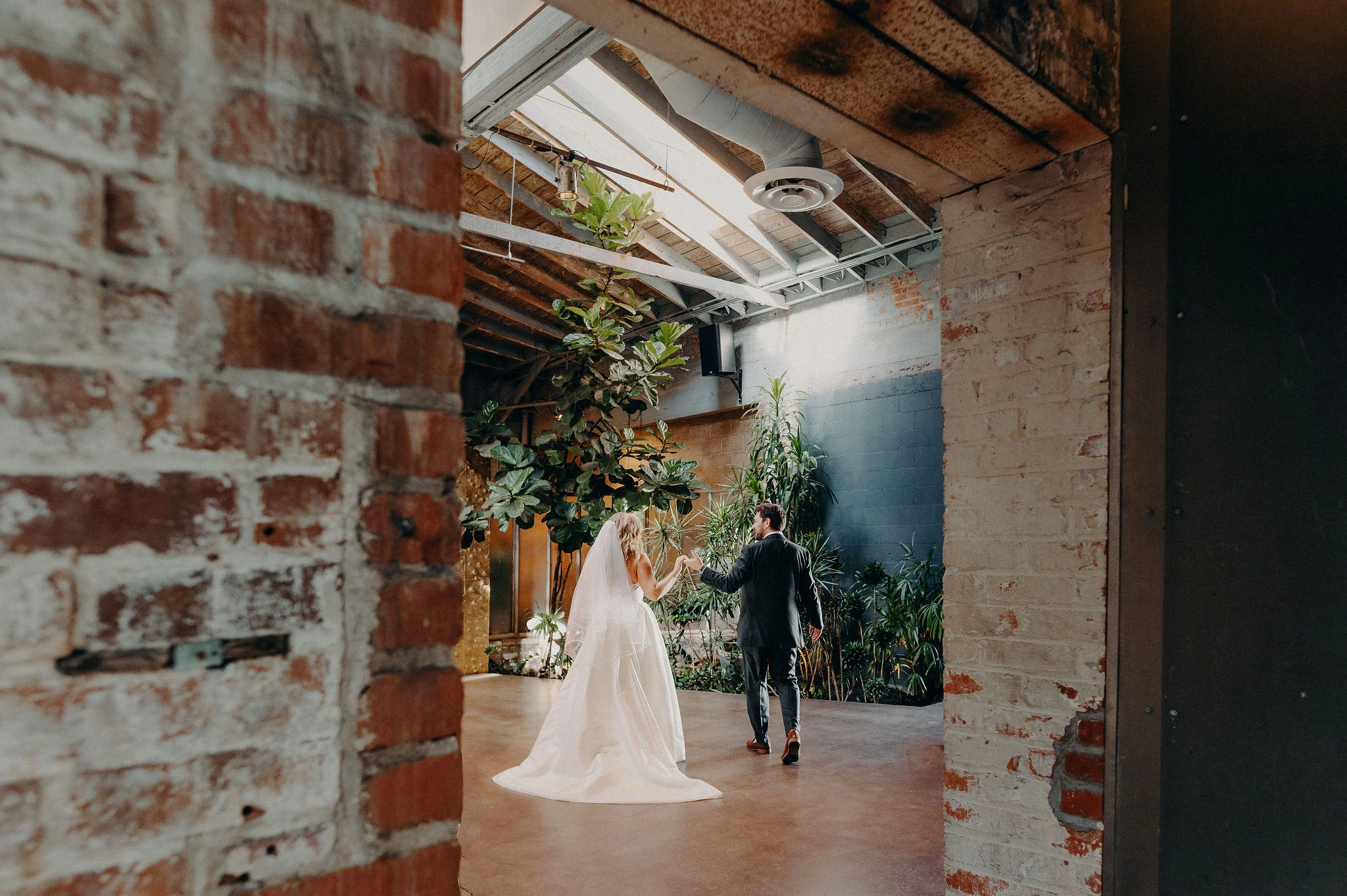 A couple framed by the Grand Hall brickwork at Millwick