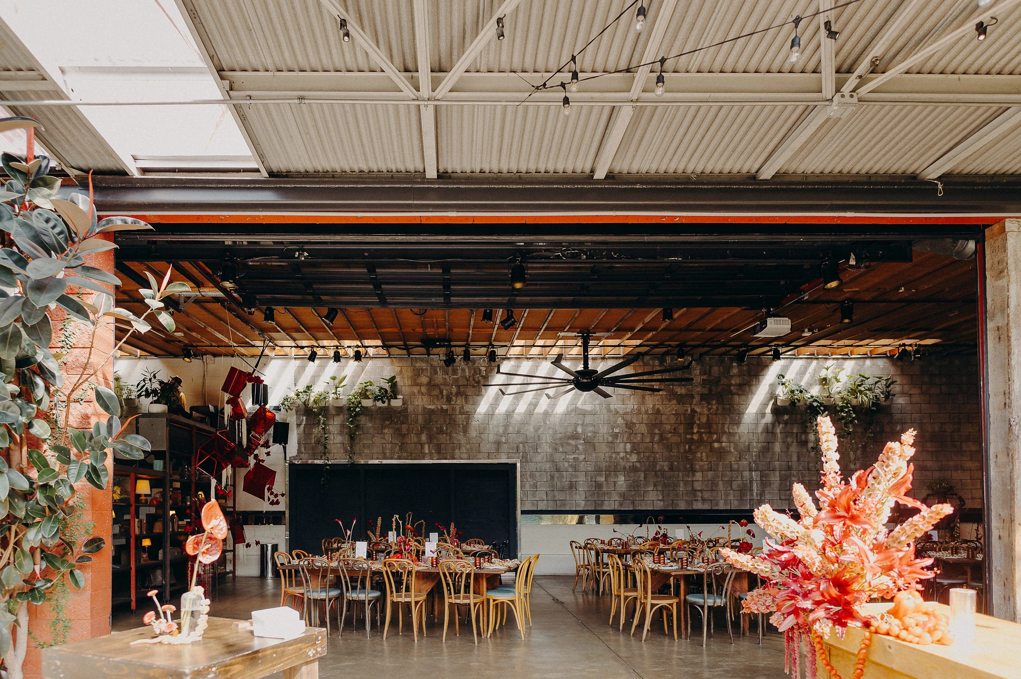 Dinner tables and flowers inside SmogShoppe’s Grand Hall